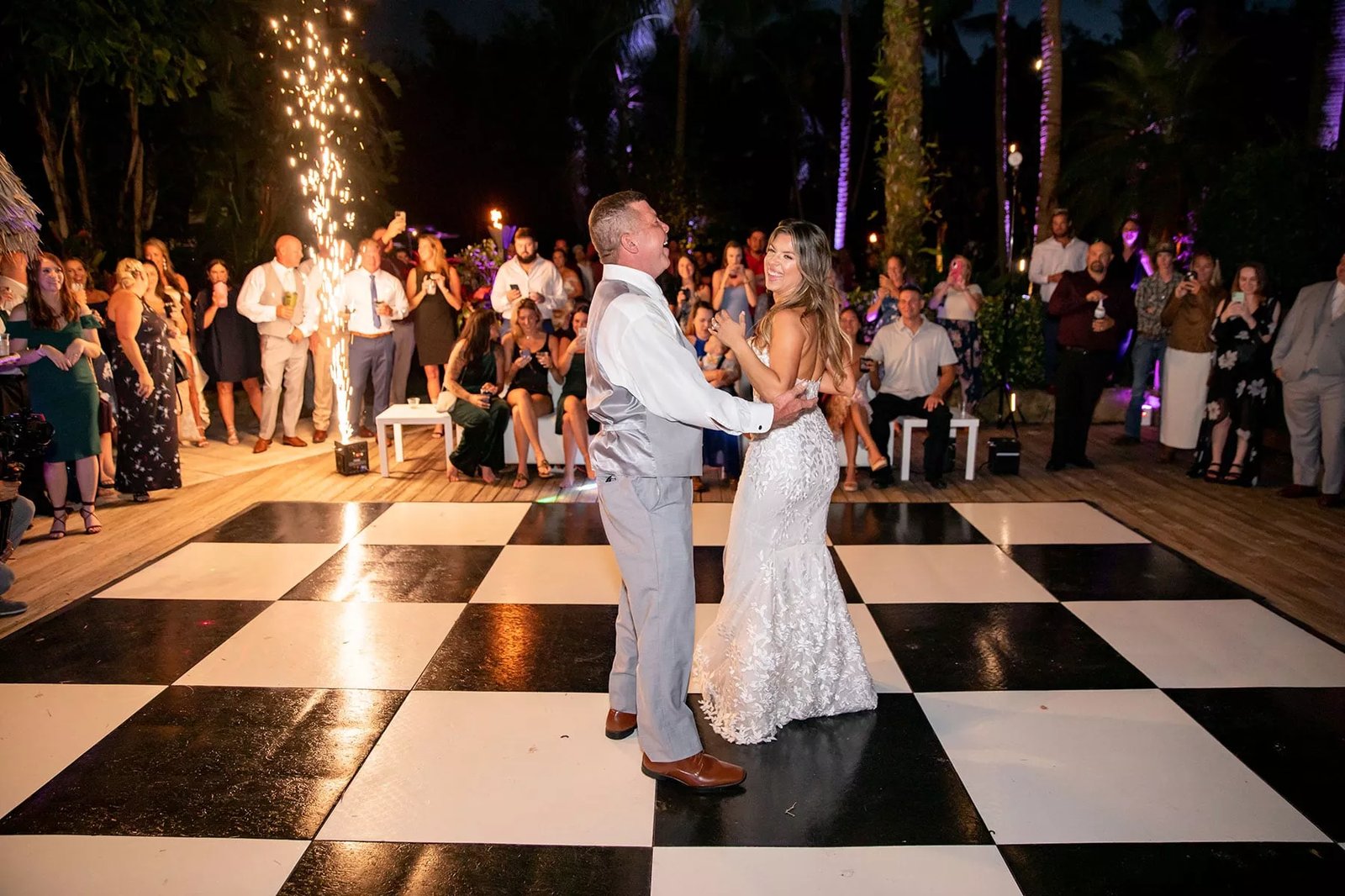 Checkered dance floor set up in a chandelier lit ballroom reception in San Francisco