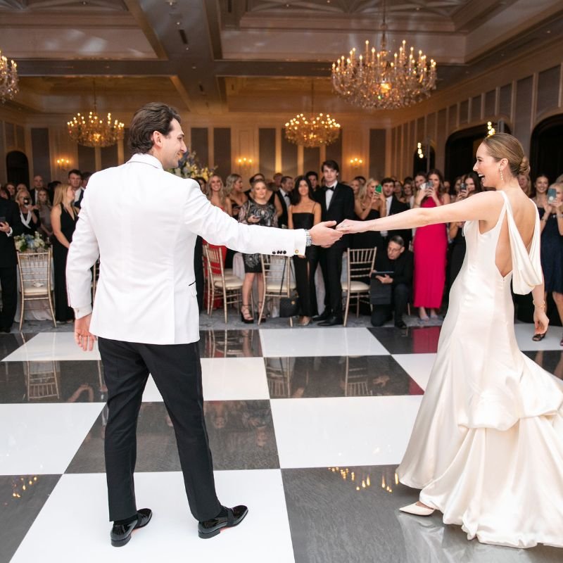 Black and white checkered dance floor rental set up in a San Francisco ballroom for a wedding reception