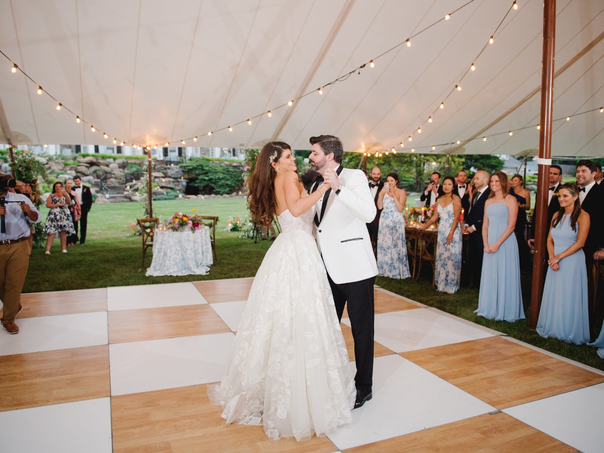 Couple's first dance on a checkered dance floor at a San Francisco reception